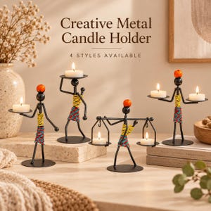 May include: Four black metal candle holders shaped like stylized figures, each featuring a round base, a small orange bead head, and colorful yellow and blue-red wrapped wire accents. Each figure supports one or two white tea light candles.