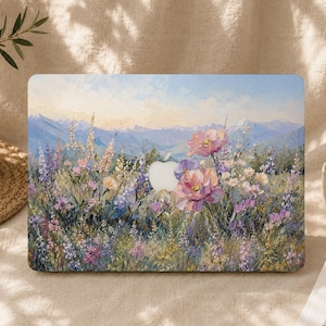 Puede incluir: Una funda rectangular para portátil con una pintura al óleo impresionista de un prado de flores silvestres. La escena muestra flores rosas, moradas y amarillas sobre un fondo de montañas azules lejanas bajo un cielo suave y claro.