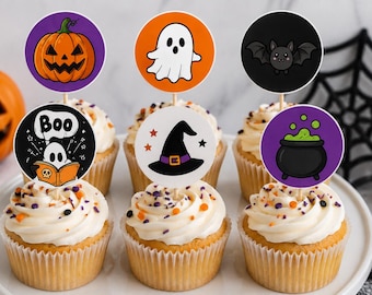 May include: Six cupcakes topped with round paper toppers featuring Halloween illustrations including a jack-o'-lantern, a ghost, a bat, a ghost reading a book with the text Boo, a witch hat, and a bubbling cauldron on a white cake stand.
