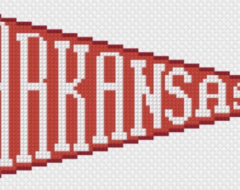 May include: A triangular red pennant featuring the word ARKANSAS in bold white block letters. The design is rendered in a pixelated cross-stitch style with two red ties extending from the left side of the banner against a white grid background.