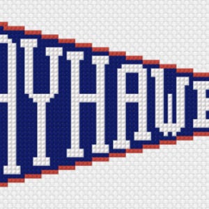 May include: A triangular pennant featuring a dark blue background with a red border and the white text JAYHAWKS printed in a bold, block-style font. The design is composed of a grid of small squares, creating a pixelated or cross-stitch appearance.