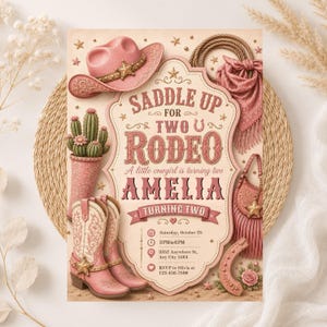 May include: A birthday invitation card featuring a pink cowboy hat, cactus in a boot, cowboy boots, a lasso, and a fringed bag. The text reads: SADDLE UP FOR TWO RODEO, A little cowgirl is turning two, AMELIA, TURNING TWO, Saturday, October 28, 3 PM to 6 PM, 3352 Anywhere St, Any City 5564, RSVP to Olivia at 123-456-7890.