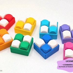 May include: Eight square containers, each holding four rounded cubes. The containers and cubes feature various colors including red, yellow, turquoise, purple, orange, green, blue, and pink, with white cubes interspersed throughout the sets.