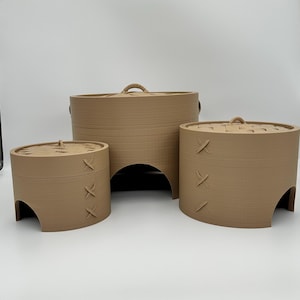 May include: Three light brown, cylindrical, 3D-printed containers with arched cutouts at the base and removable lids. Each lid features a woven-style pattern and a small central handle. The sides of the containers display horizontal layer lines.