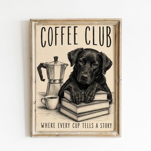 May include: A framed wall art print featuring a black Labrador dog resting its paws on a stack of three books next to a moka pot and a coffee cup. The text reads COFFEE CLUB at the top and WHERE EVERY CUP TELLS A STORY at the bottom in black ink.