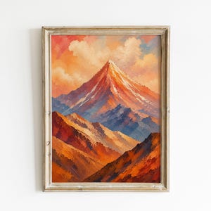 Puede incluir: Una impresión artística enmarcada que presenta una pintura al óleo de un pico de montaña puntiagudo bajo un cielo al atardecer. El paisaje muestra tonos vibrantes de naranja, rojo y azul con pinceladas visibles en un marco de madera.
