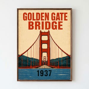 May include: A framed poster featuring a stylized illustration of the Golden Gate Bridge in red, set against a cream background with dark blue mountains and water. The text reads GOLDEN GATE BRIDGE at the top and 1937 at the bottom in black.