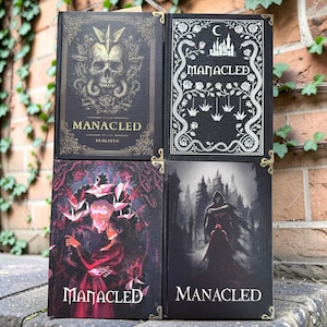 May include: Four hardcover books titled Manacled by Senlinyu. The top left cover features a gold skull and geometric crown. The top right cover shows a white castle, snakes, and origami cranes. The bottom covers display dark, illustrated scenes.