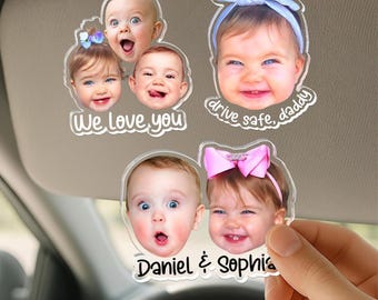 May include: Three clear acrylic car visor clips featuring printed photographs of children's faces. One clip shows three children with the text "We Love You," another shows one child with "drive safe, daddy," and the third shows two children with "Daniel & Sophia."