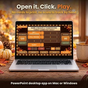 Laptop open on a wooden table displaying the Fall Friendly Feud game next to pumpkins, autumn leaves, and a mug of coffee.