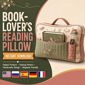 May include: A rectangular quilted reading pillow featuring a cream background with a small floral and book print, a sage green front pocket with floral embroidery, a top handle, and a side pocket containing a pair of glasses and a green book.