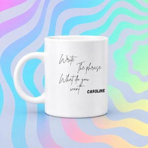 May include: A white ceramic mug featuring black text that reads Write The phrase What do you want CAROLINE. The mug has a standard handle and a cylindrical body, presented against a background of swirling pastel rainbow-colored waves.
