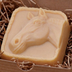 May include: A light brown soap bar with a horse head design. The soap is in a small cardboard box with brown paper shreds.