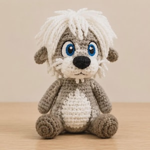May include: A handcrafted crochet plush toy featuring a grey body with a white belly, white hair, and large blue eyes. The creature has a black nose, small ears, and a textured yarn construction. It sits in an upright position with rounded feet.
