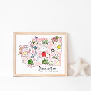 K&ouml;nnte beinhalten: Eine gerahmte Aquarellillustration des Bundesstaates Washington mit ikonischen Sehensw&uuml;rdigkeiten und Symbolen wie dem Space Needle, Bergen, einer Kaffeetasse, einem Apfel und einer Birne. Der Text "Washington, The Evergreen State" befindet sich am unteren Rand der Illustration.
