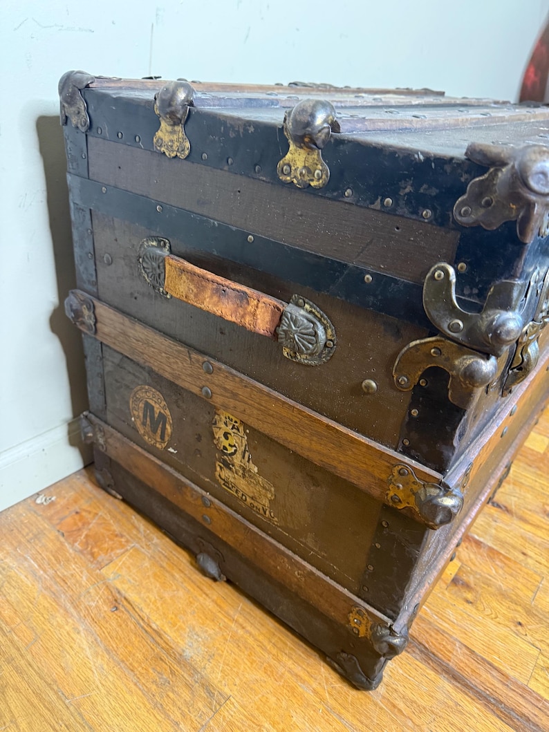 Close-up of the original solid wood slats and metal rivets on the lid of the 1890s canvas-covered trunk