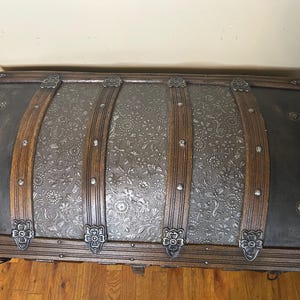 Top-down view of the high-profile arched lid on a rare tin Victorian chest.