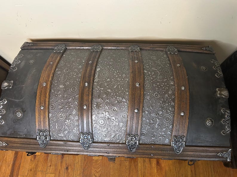 Top-down view of the high-profile arched lid on a rare tin Victorian chest.