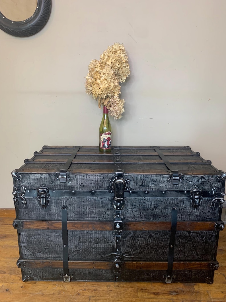 Huge refurbished antique steamer trunk in black with buffed bright hardware