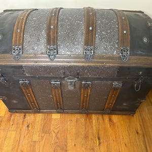 Hand-polished original metal hardware and rivets on a restored Saratoga trunk.