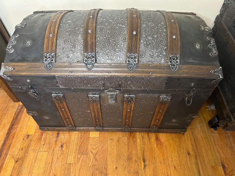 Hand-polished original metal hardware and rivets on a restored Saratoga trunk.