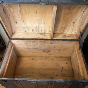 Inside view of an exceptionally clean original antique trunk interior.