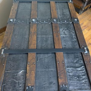 Massive travel chest showing custom leather straps and new leather handles
