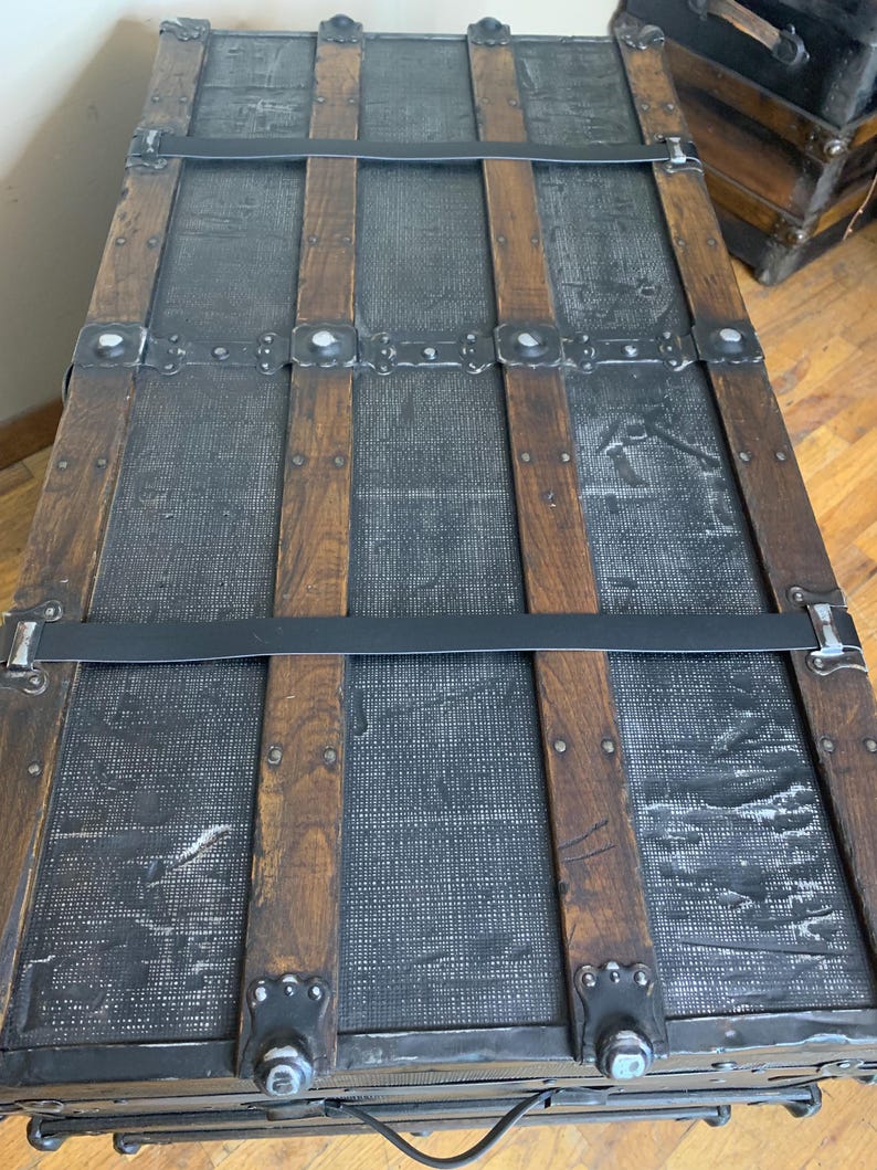 Massive travel chest showing custom leather straps and new leather handles