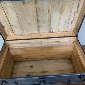 Inside view of a huge antique trunk with a clean stripped and sanded interior