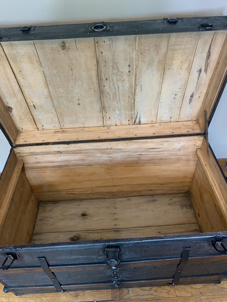 Inside view of a huge antique trunk with a clean stripped and sanded interior