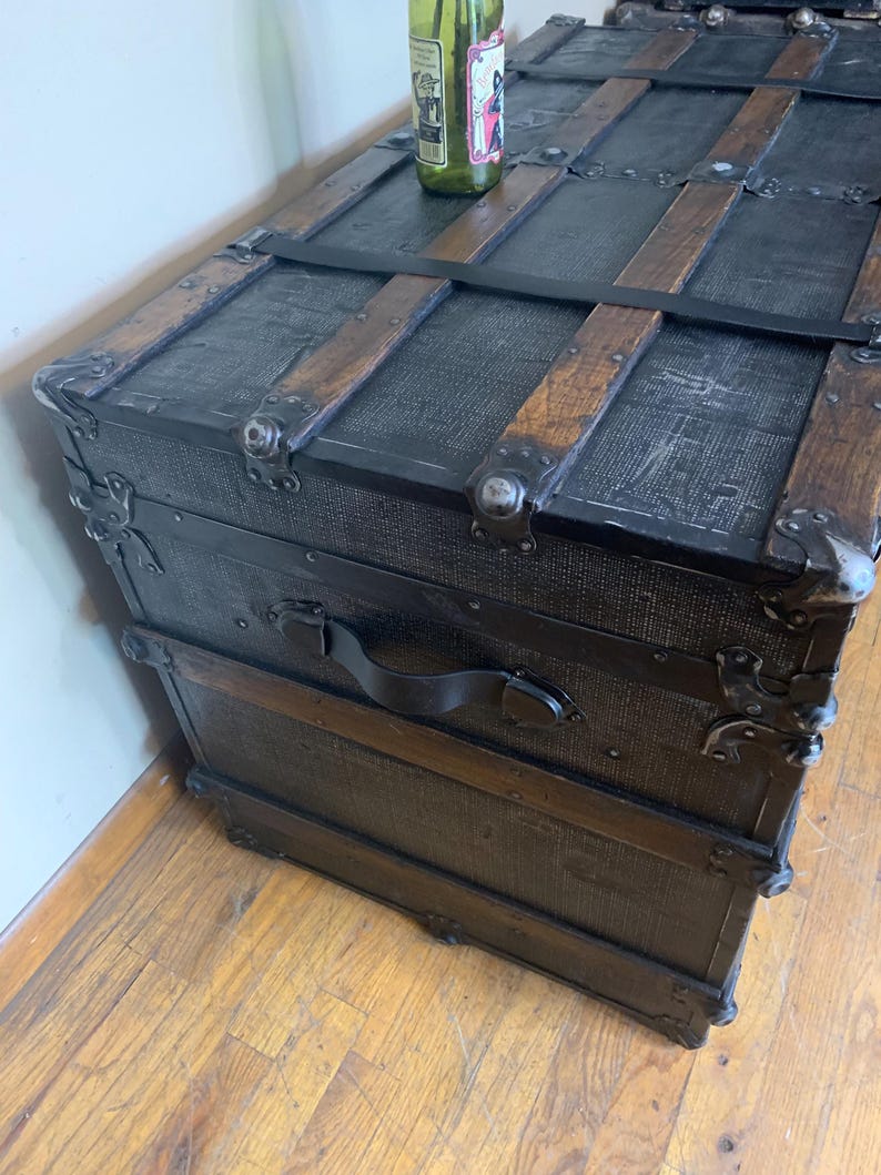 Side profile of a huge 19th century travel chest refinished in black