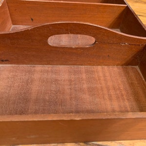 May include: A wooden tray with three compartments and a handle. The tray is made of dark wood and has a natural finish.