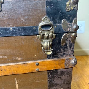 Detailed shot of the original antique metal latches and lock in authentic, weathered 1890s condition