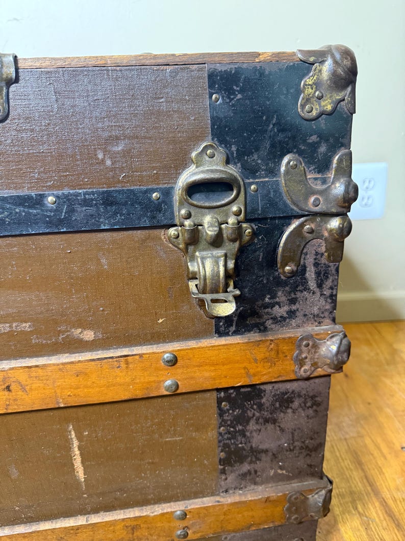 Detailed shot of the original antique metal latches and lock in authentic, weathered 1890s condition