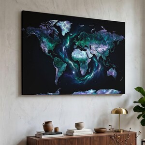May include: A rectangular wall art piece featuring a world map design against a solid black background. The continents are rendered in swirling shades of teal, blue, and purple, resembling a nebula or cosmic cloud formation with glowing light.