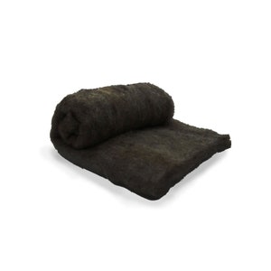 May include: A rolled-up, dark brown, rectangular felt pad. The felt is thick and appears to be made of natural fibers. The pad is partially unrolled, revealing its texture and thickness. The item is likely used for crafts or insulation.