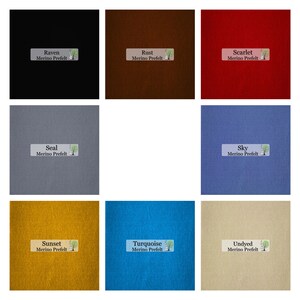 May include: Nine squares of Merino Prefelt fabric in various colors. Colors include Raven, Rust, Scarlet, Seal, Sky, Sunset, Turquoise, and Undyed. Each square has a label with the color name and "Merino Prefelt".