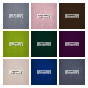 May include: Nine squares of merino wool prefelt in various colors. Colors include ash, candy floss, chocolate, citrus, conifer, damson, eggshell, fusion, and granite. Each square has a label with the color name and "Merino Prefelt".