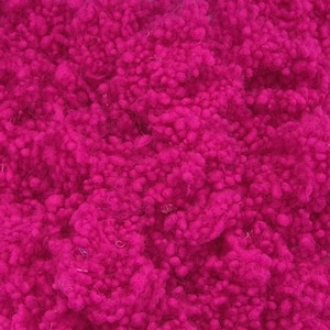 May include: Close-up of a vibrant fuchsia-colored fabric with a textured, looped surface. The material appears soft and plush, with a dense, irregular pattern. The color is consistent throughout, creating a visually rich and tactile experience. Ideal for textiles and crafts.
