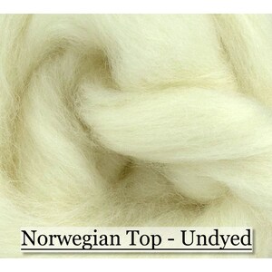 May include: Close-up of undyed Norwegian Top wool fibers. The fibers are a creamy off-white color, tightly packed, and appear soft and fluffy. The text "Norwegian Top - Undyed" is displayed at the bottom of the image.