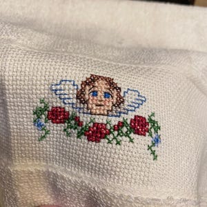 May include: A white ceramic mug with a black handle and the text "But First, Coffee" in a black, bold font. The mug is on a white surface.