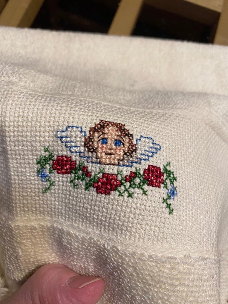 May include: A white ceramic mug with a black handle and the text "But First, Coffee" in a black, bold font. The mug is on a white surface.