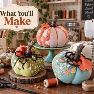 May include: Three fabric pumpkins featuring floral and solid patterns in orange, green, and blue. Each pumpkin has a dark brown twig stem and dark brown coiled wire accents. The text "What You'll Make" is displayed in a decorative frame above them.