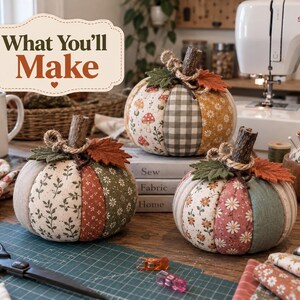May include: Three fabric pumpkins featuring various patterns including mushrooms, gingham, and floral prints. Each pumpkin has a brown twig stem, a jute twine bow, and felt leaves. A sign above reads "What You'll Make" in brown and orange text.