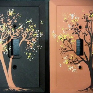 Wie-ein Satz aus zwei handbemalten Lichtschalter-Abdeckungen