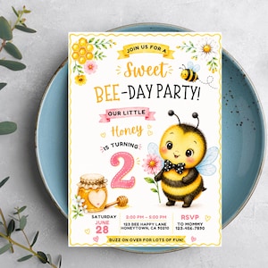 May include: A rectangular party invitation with a scalloped yellow border featuring a cartoon bee wearing a black and white polka dot bow tie, a honey jar, a large pink number 2, and text reading JOIN US FOR A SWEET BEE-DAY PARTY! OUR LITTLE HONEY IS TURNING 2.