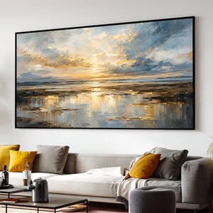 May include: A large rectangular landscape painting featuring a sunset over a body of water. The sky is filled with textured clouds in shades of gold, white, and blue. The water reflects the golden light, with dark brown land masses visible.