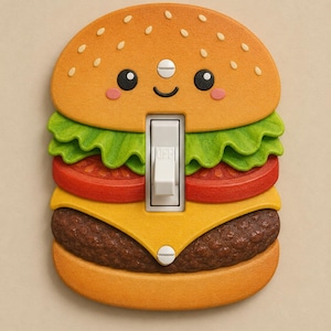 Peut inclure: Une plaque d'interrupteur en forme de hamburger avec un visage souriant. Le design comprend un pain beige avec des graines de sésame, de la laitue verte, une tranche de tomate rouge, du fromage jaune et un steak brun. Un interrupteur blanc est au centre.