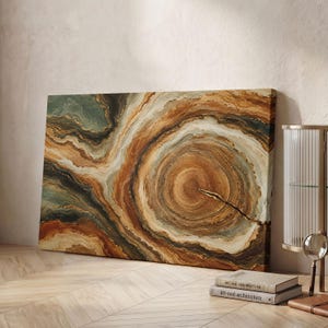 May include: A rectangular canvas wall art piece featuring an abstract design of concentric rings in shades of brown, tan, cream, and muted green, resembling the cross-section of a tree trunk with a prominent crack extending from the centre.