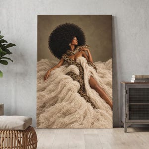 May include: A vertical wall art print featuring a person with a large afro hairstyle draped in a long, textured, cream-colored fabric. A large patterned snake is coiled around the person's shoulders and torso against a muted brown background.